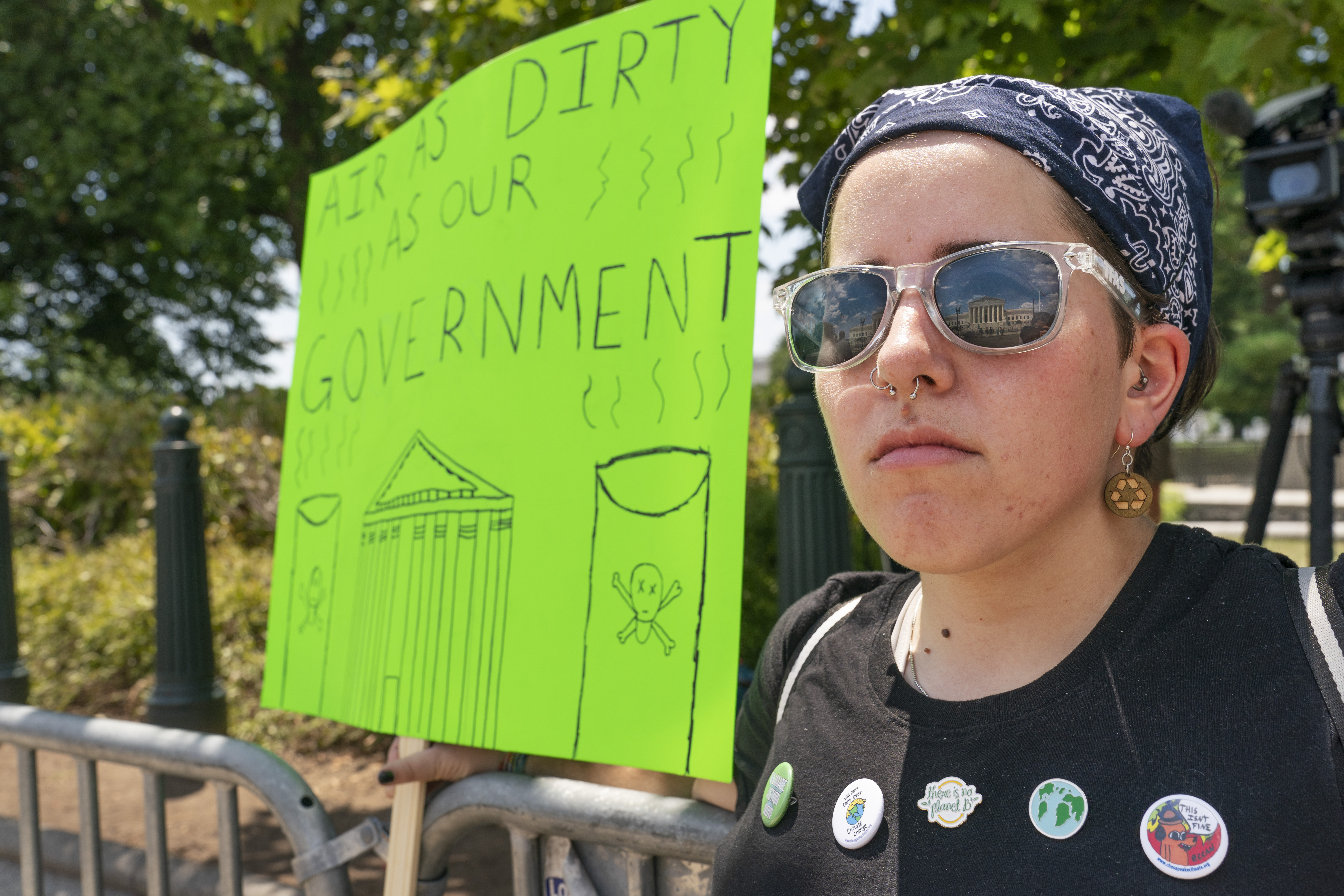 A woman protest against climate change after the Supreme Court's EPA decision.
