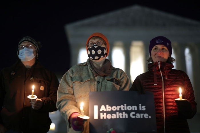 Nightly 12-16-21 photo 3 Activists participate in a candlelight vigil on abortion rights in front of the U.S. Supreme Court.