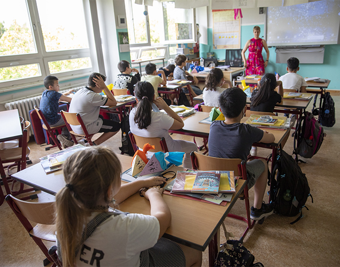 Children sit for the first day of classes of the new school year at the GuthsMuths elementary school as the teacher explains them the new rules during the coronavirus pandemic in Berlin, Germany.