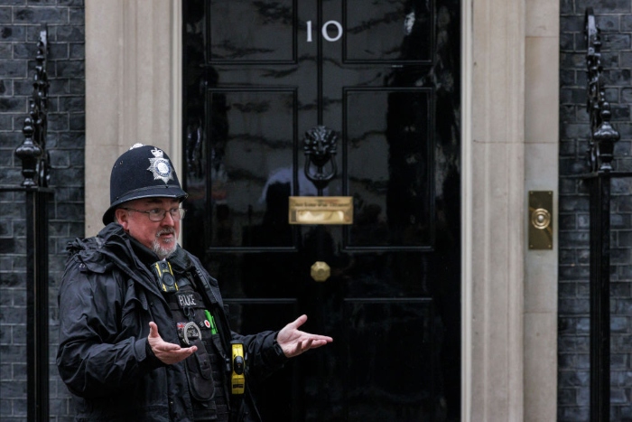 A police officer stands outside 10 Downing Street in London.