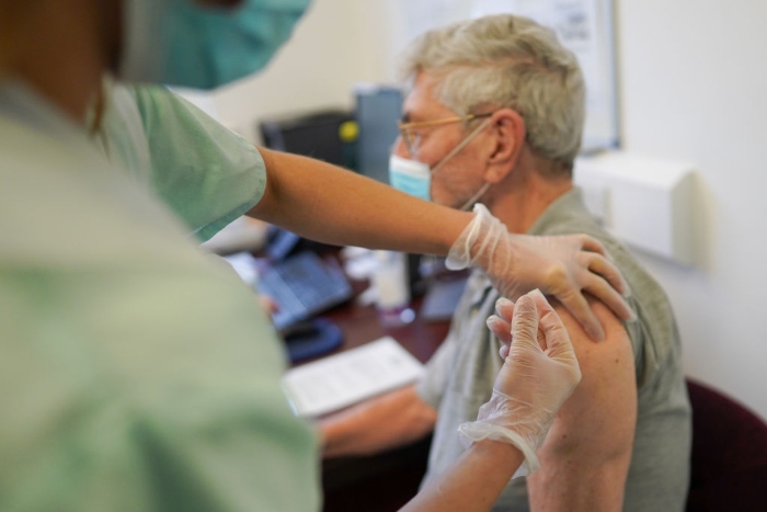 Nightly 7-15-21 photo A patient is given his Pfizer BioNTech Covid-19 vaccination by a doctor at Haxby and Wiggington Surgery in York, England.