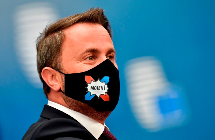 Prime Minister of Luxembourg Xavier Bettel arrives at the EU budget summit in Brussels wearing a mask that says 