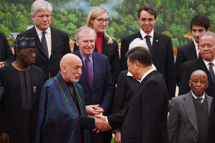 Nightly 8-19-21 photo 1 Chinese President Xi Jinping shakes hands with former Afghanistan President Hamid Karzai before posing for a photo at the Great Hall of the People in Beijing in 2019.