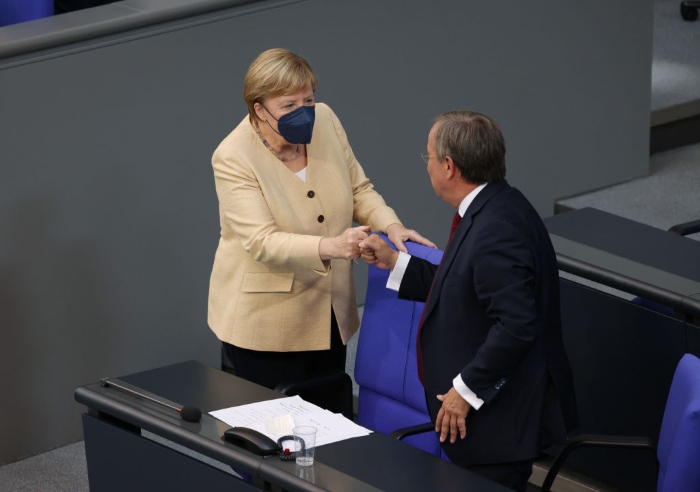 Nightly 9-7-21 photo 3 German Chancellor Angela Merkel greets Armin Laschet, chancellor candidate of the Christian Democrats, after Laschet spoke at the final session of the Bundestag before federal parliamentary elections in Berlin.