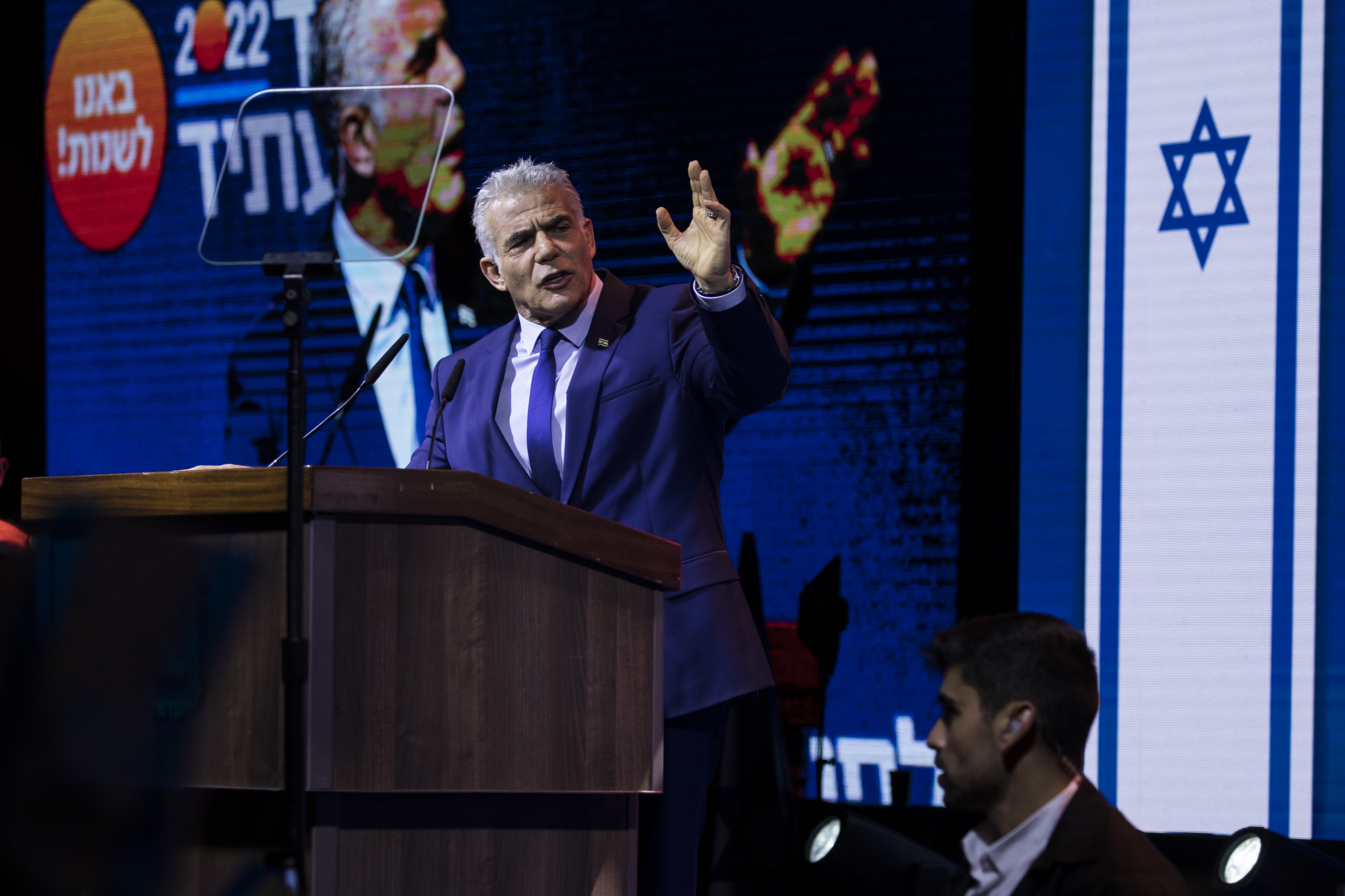 A photo of Israeli Prime Minister Yair Lapid speaking at a rally. 