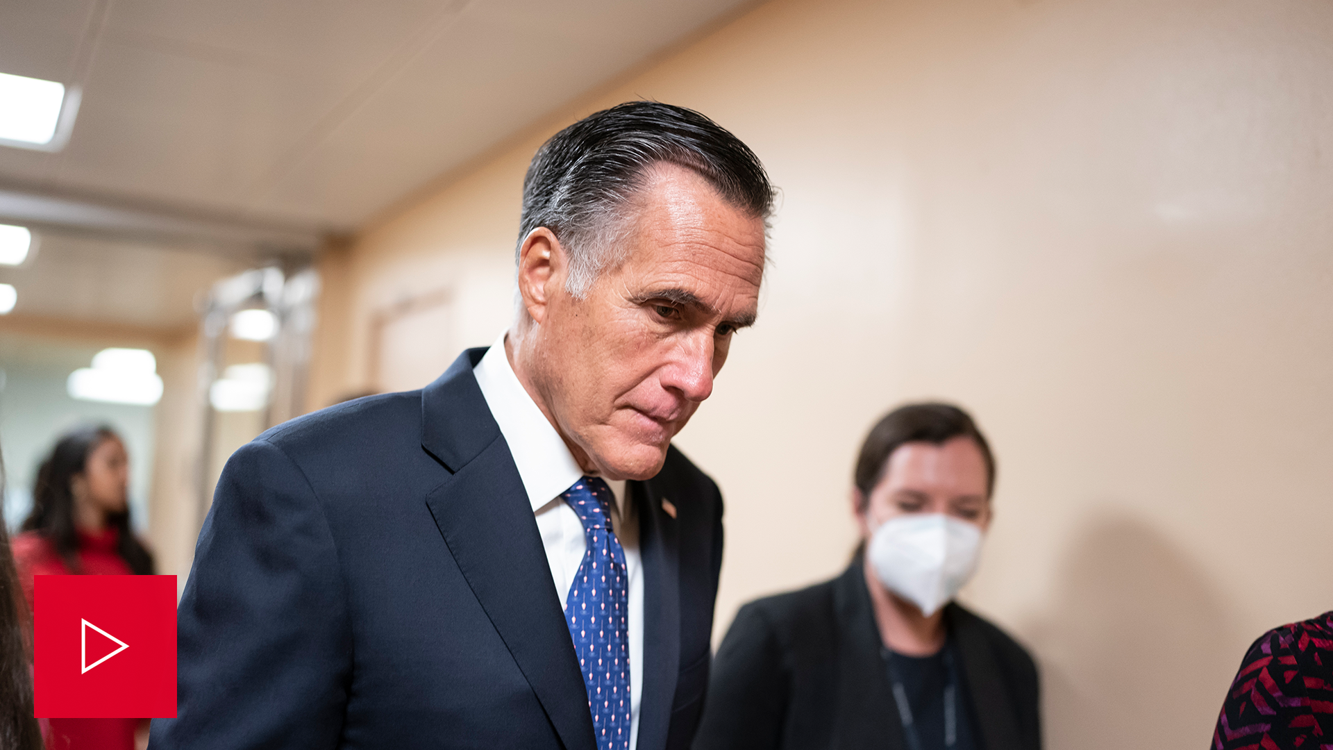 Sen. Mitt Romney walks in the Capitol.