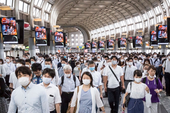 Nightly 7-10 photo Commuters wearing face masks pass through Shinagawa train station in Tokyo.