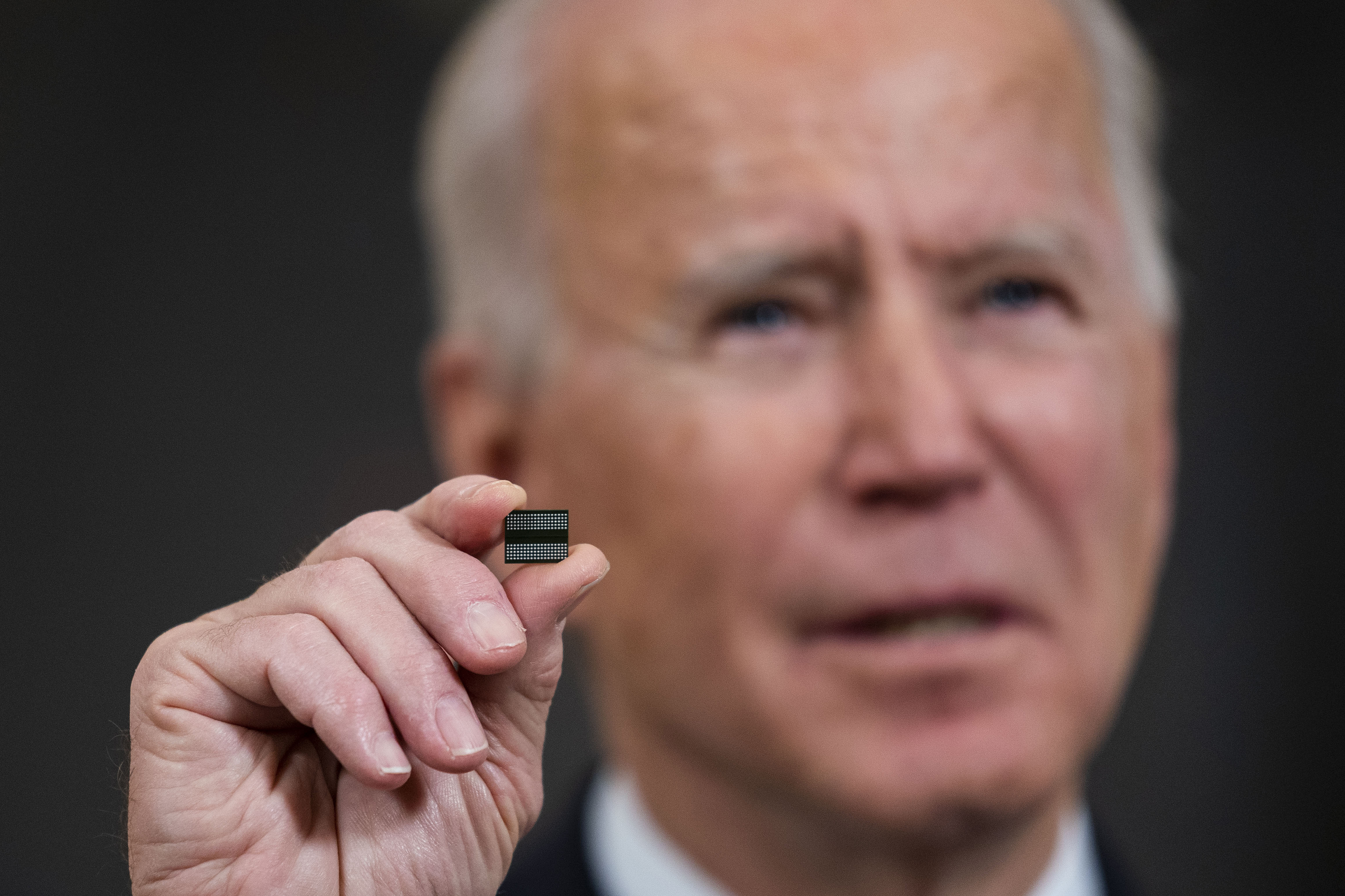 Joe Biden holds a semiconductor.