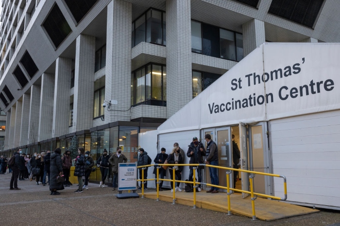 Nightly 12-14-21 photo Members of the public line up for Covid-19 vaccinations and booster jabs at St Thomas' Hospital in London.