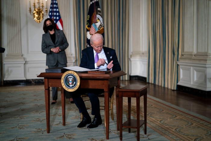 President Joe Biden signs executives orders related to his racial equity agenda in the State Dining Room of the White House.