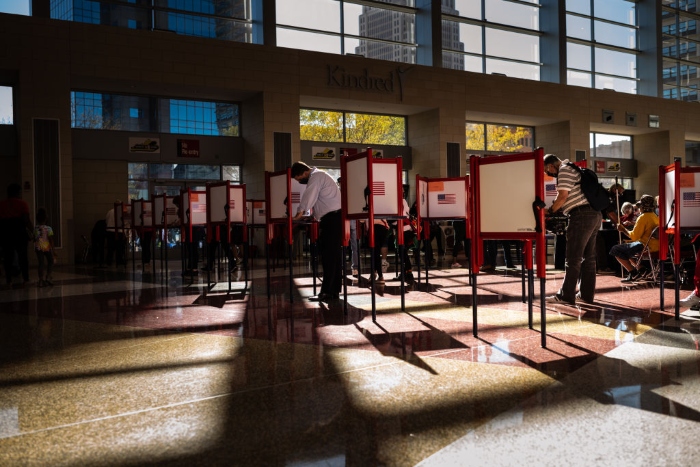 Voters fill out their ballots during early voting at the KFC YUM! Center in Louisville, Ky. 