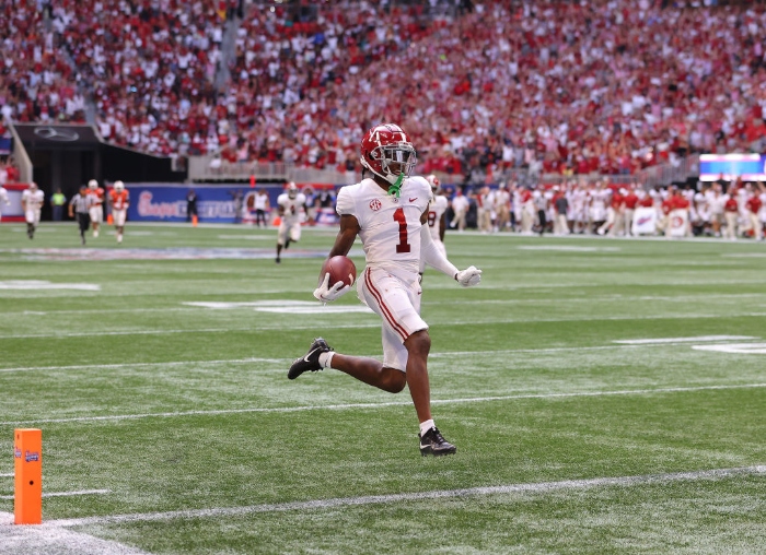 Nightly 9-8-21 photo 2 Jameson Williams of the Alabama Crimson Tide reacts as he takes a long reception for a touchdown against the Miami Hurricanes during the second half of the Chick-fil-A Kick-Off Game at Mercedes-Benz Stadium in Atlanta.