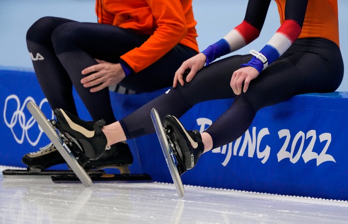 20220203_Nightly_olympics_700 Athletes from The Netherlands sit at the edge of the ice during a practice session ahead of the 2022 Winter Olympics in Beijing.