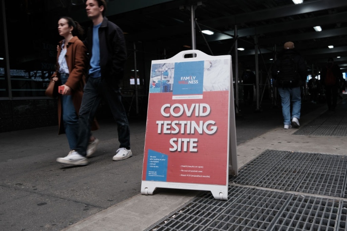People walk by a Covid-19 testing site in downtown Manhattan in New York City.