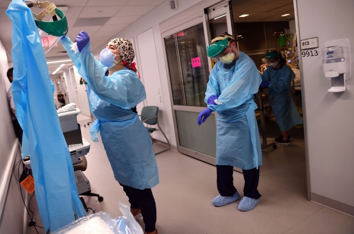 Nightly 8-11-21 main photo Clinicians depart a patient room after repositioning a Covid-19 patient into the supine position in the ICU at Lake Charles Memorial Hospital in Lake Charles, La.