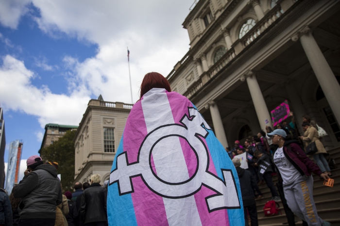 LGBT activists and their supporters rally in support of transgender people on the steps of New York City Hall.
