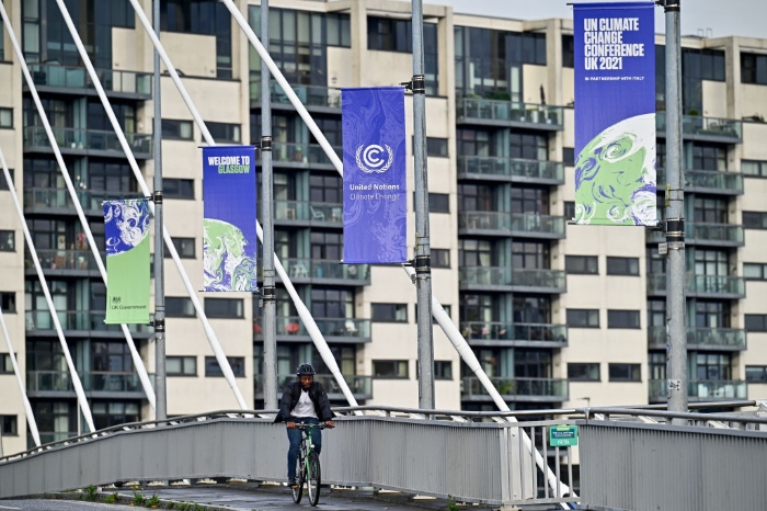 Nightly 10-25-21 photo 2 Members of the public cross the Clyde Arc road bridge by the Scottish Events Center, which will be hosting the COP26 U.N. Climate Summit in Glasgow, Scotland.