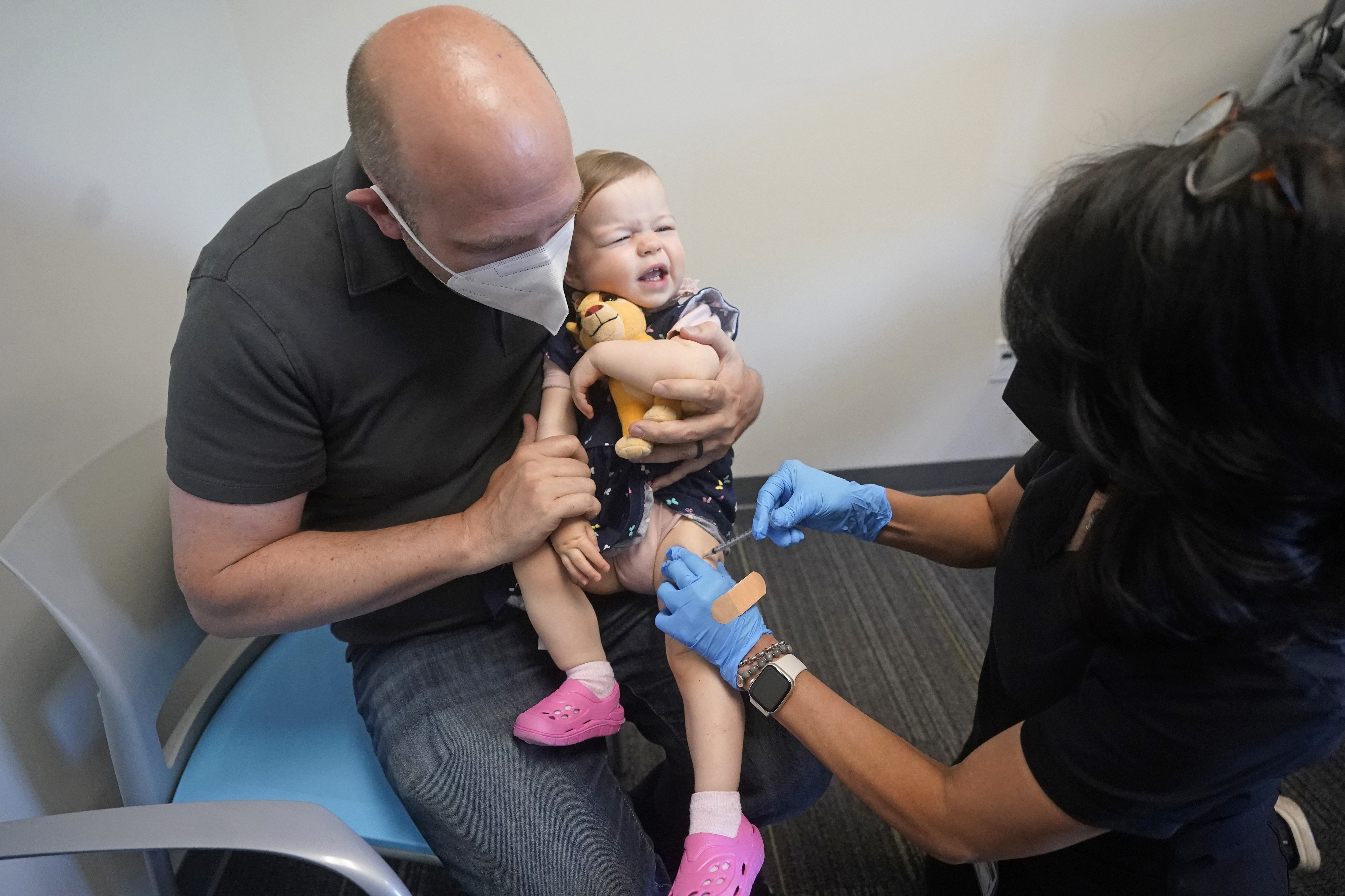 Michael Rupp holds his daughter Lennox, 16 months, as she receives the Moderna COVID-19 vaccination Tuesday, June 21, 2022, in Salt Lake City. 