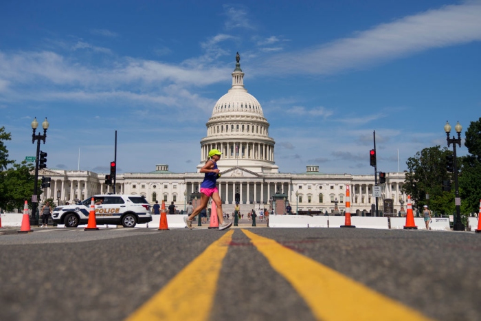 Nightly 7-16-21 photo A woman jogs past the U.S. Capitol.