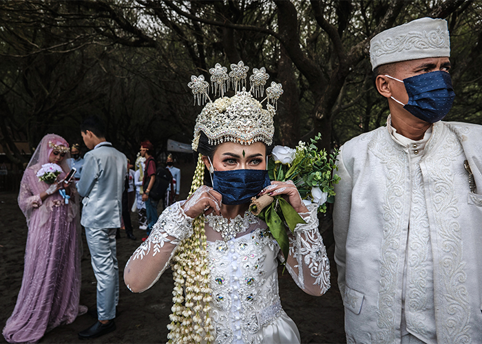 A bride and groom wearing protective masks as they attend a mass wedding to commemorate the 75th Indonesia's National Independence Day.
