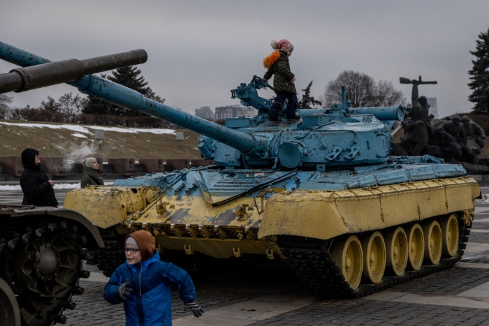 Children play on tanks displayed at the Motherland Monument in Kyiv, Ukraine