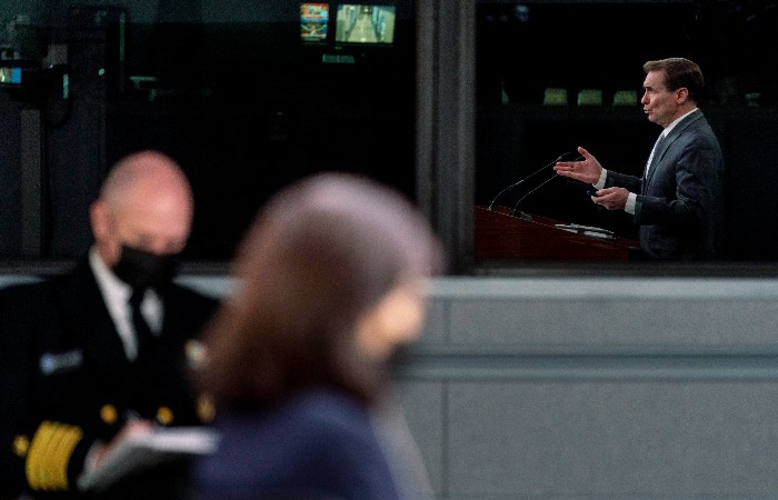20220202_Nightly_Kirby_700 Pentagon spokesperson John Kirby, seen in reflection, speaks during a briefing at the Pentagon in Washington.