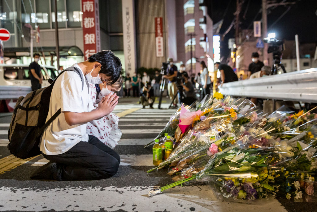 People pray at a site outside of Yamato-Saidaiji Station where Japan’s former Prime Minister Shinzo Abe was shot.