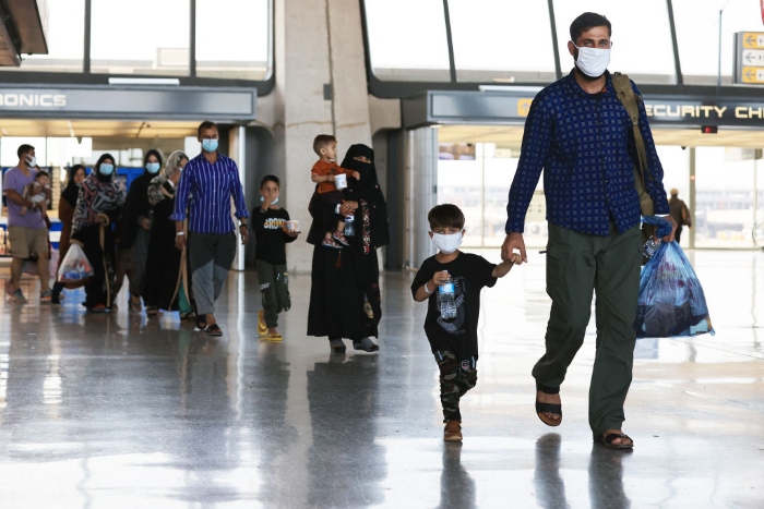 Nightly 8-27-21 photo 2 Refugees arrive at Dulles International Airport in Virginia after being evacuated from Kabul following the Taliban takeover of Afghanistan .