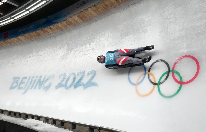 20220202_Nightly_olympics_700 Wolfgang Kindl of Austria speeds past the Olympic rings during a men's luge training run at the 2022 Winter Olympics in the Yanqing district of Beijing.