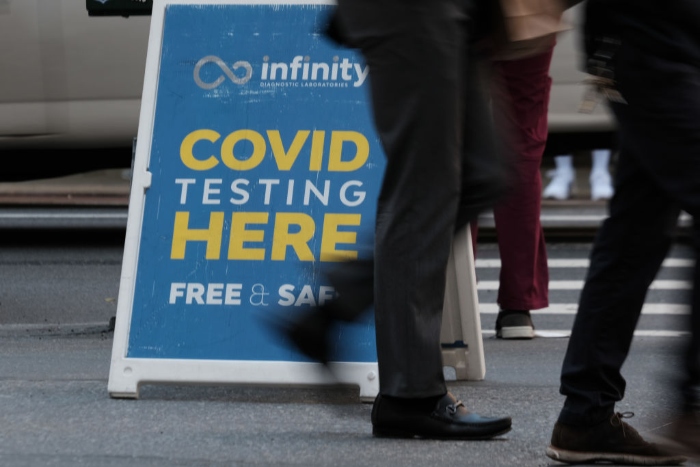People walk past a Covid testing site in New York City.