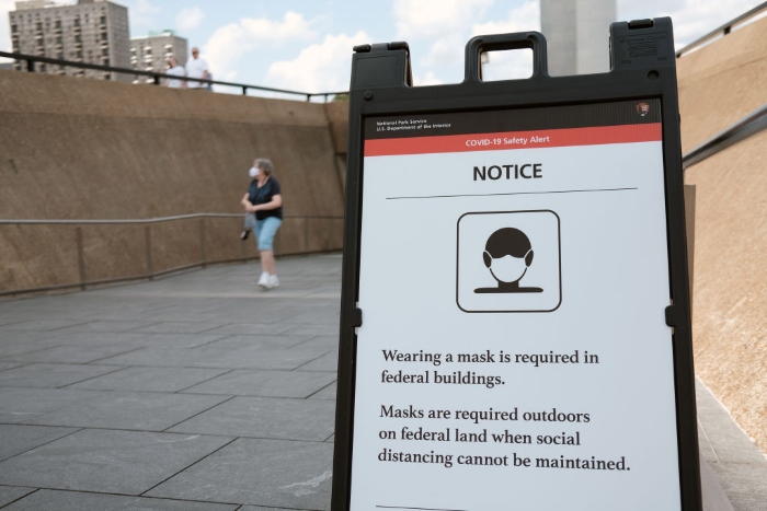 Nightly 8-4-21 photo A sign reminds visitors to mask as people tour the Gateway Arch in downtown St. Louis.