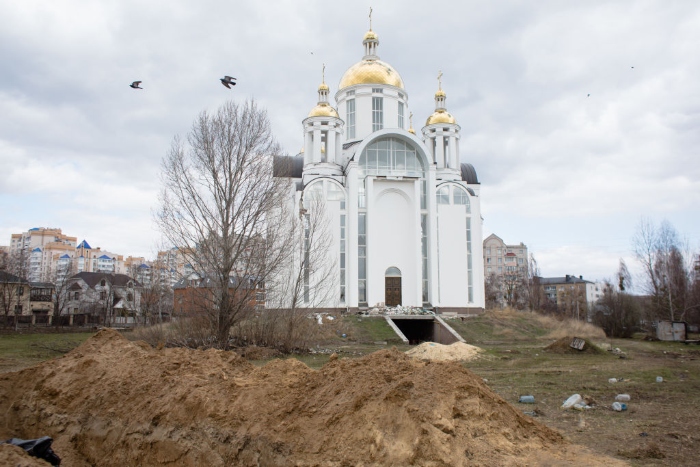 A view of a mass grave by a church in Bucha, Ukraine.