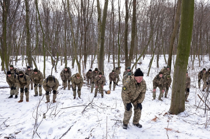 Nightly 1-26-22 photo 2 Civilian participants in a Kyiv Territorial Defense unit warm up while training on a Saturday in a forest in Kyiv, Ukraine.