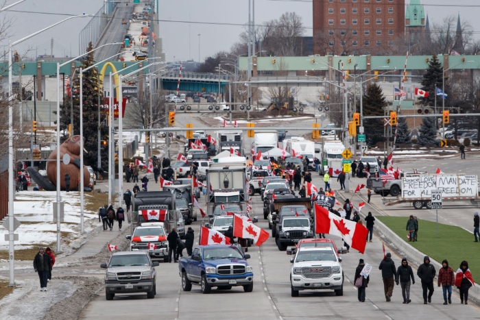 Nightly 2-10-22 canada Protestors and supporters set up at a blockade at the foot of the Ambassador Bridge, sealing off the flow of commercial traffic over the bridge into Canada from Detroit in Windsor, Canada.