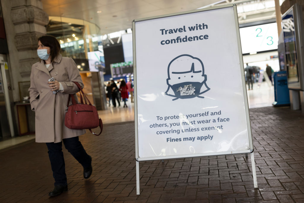 A photo of a sign asking passengers to wear a mask.