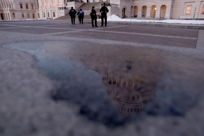 Nightly 1-6-22 photo U.S. Capitol Police officers stand watch on the East Front plaza.
