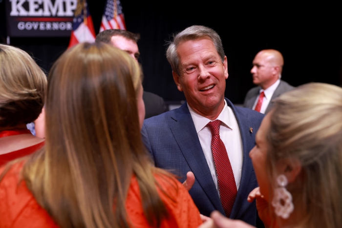 Georgia Gov. Brian Kemp greets people during a primary night election party at the Chick-fil-A College Football Hall of Fame in Atlanta. 