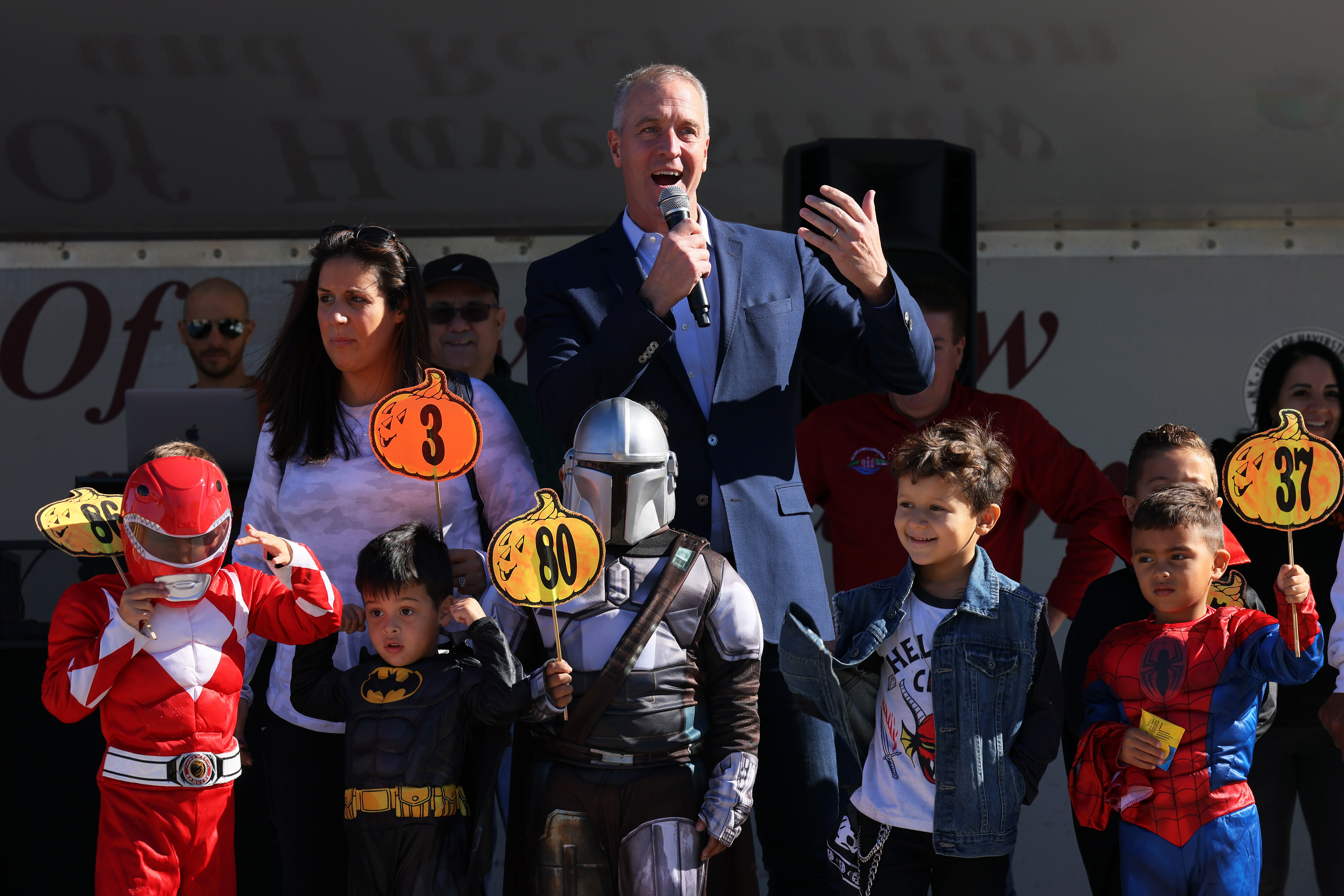 A photo of Rep. Sean Patrick Maloney talking surrounded by kids in Halloween costumes. 