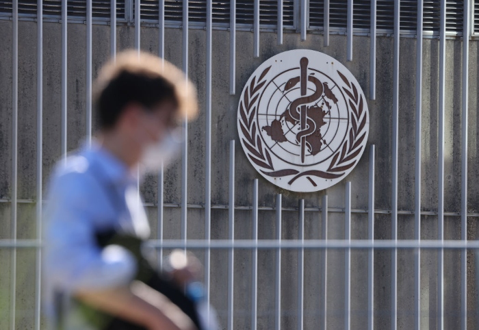 Nightly 11-29-21 photo 4 A man enters the headquarters of the World Health Organization in Geneva, Switzerland.