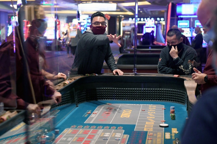 Nightly 7-2 photo A player rolls the dice at a craps table at Mandalay Bay Resort and Casino after the Las Vegas Strip property opened for the first time since being closed in mid-March.