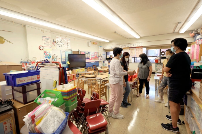 Nightly 9-13-21 photo Principal Alice Hom talks with teachers in a classroom at Yung Wing School P.S. 124 in New York City.