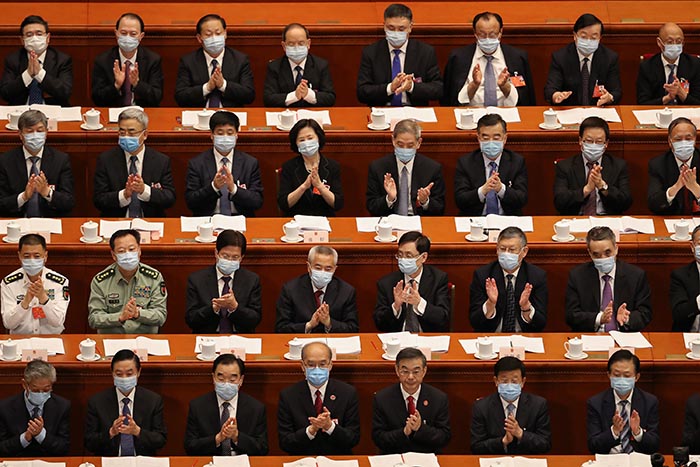 Attendees of the Second Plenary Session of the National People's Congress clap their hands during a speech.