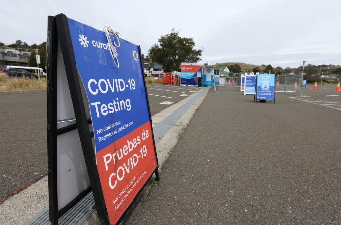 Signage is posted at a Curative Covid-19 test facility at the Larkspur Ferry terminal in Larkspur, Calif.
