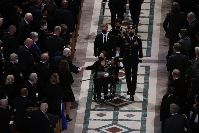 Nightly 11-5-21 photo 2 Alma Powell, widow of former Secretary of State Colin Powell, shakes hands with guests as she leads family and friends out of Washington National Cathedral following her husband's funeral service.