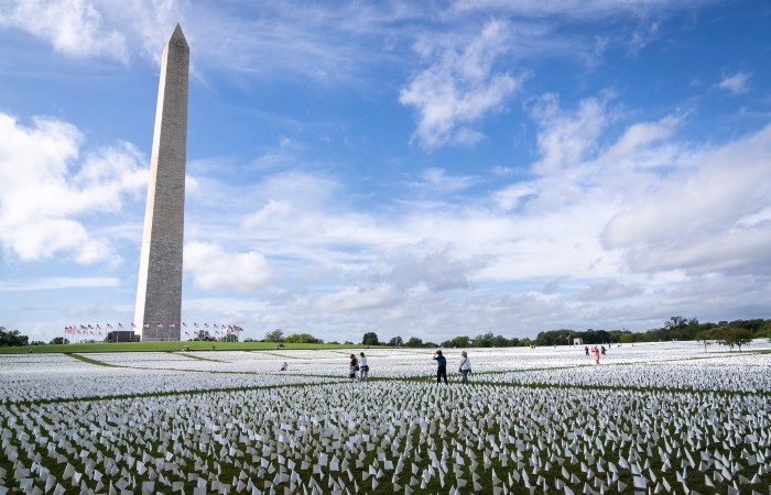 People walk through ‘In America: Remember,’ a public art installation commemorating all the Americans who have died due to Covid-19, on the National Mall Sept. 21, 2021 in Washington, D.C. 