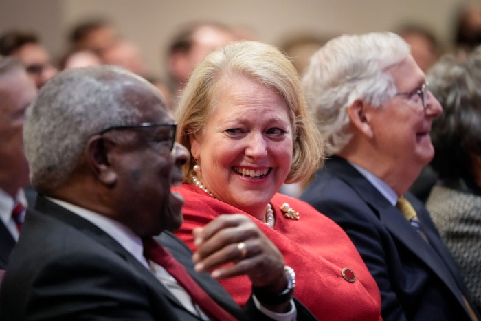 Associate Supreme Court Justice Clarence Thomas sits with his wife and conservative activist Virginia Thomas while he waits to speak at the Heritage Foundation in October in Washington.