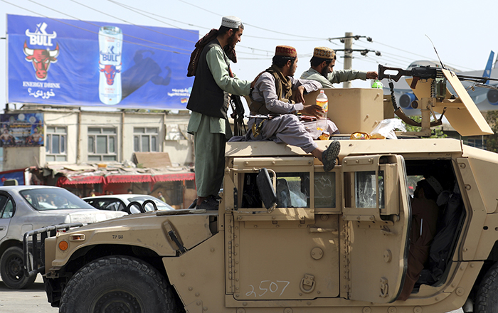 20210816-Afghanistan Taliban-AP-700 Taliban fighters stand guard in front of the Hamid Karzai International Airport.