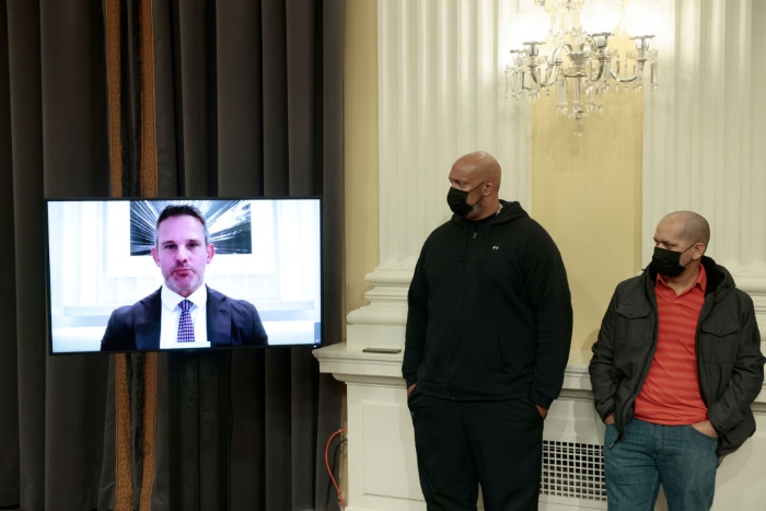 Nightly 12-17-21 photo 2 U.S. Capitol Police officers Sgt. Aquilino Gonell and Harry Dunn listen as Rep. Adam Kinzinger speaks remotely during a business meeting with the select committee on Capitol Hill.