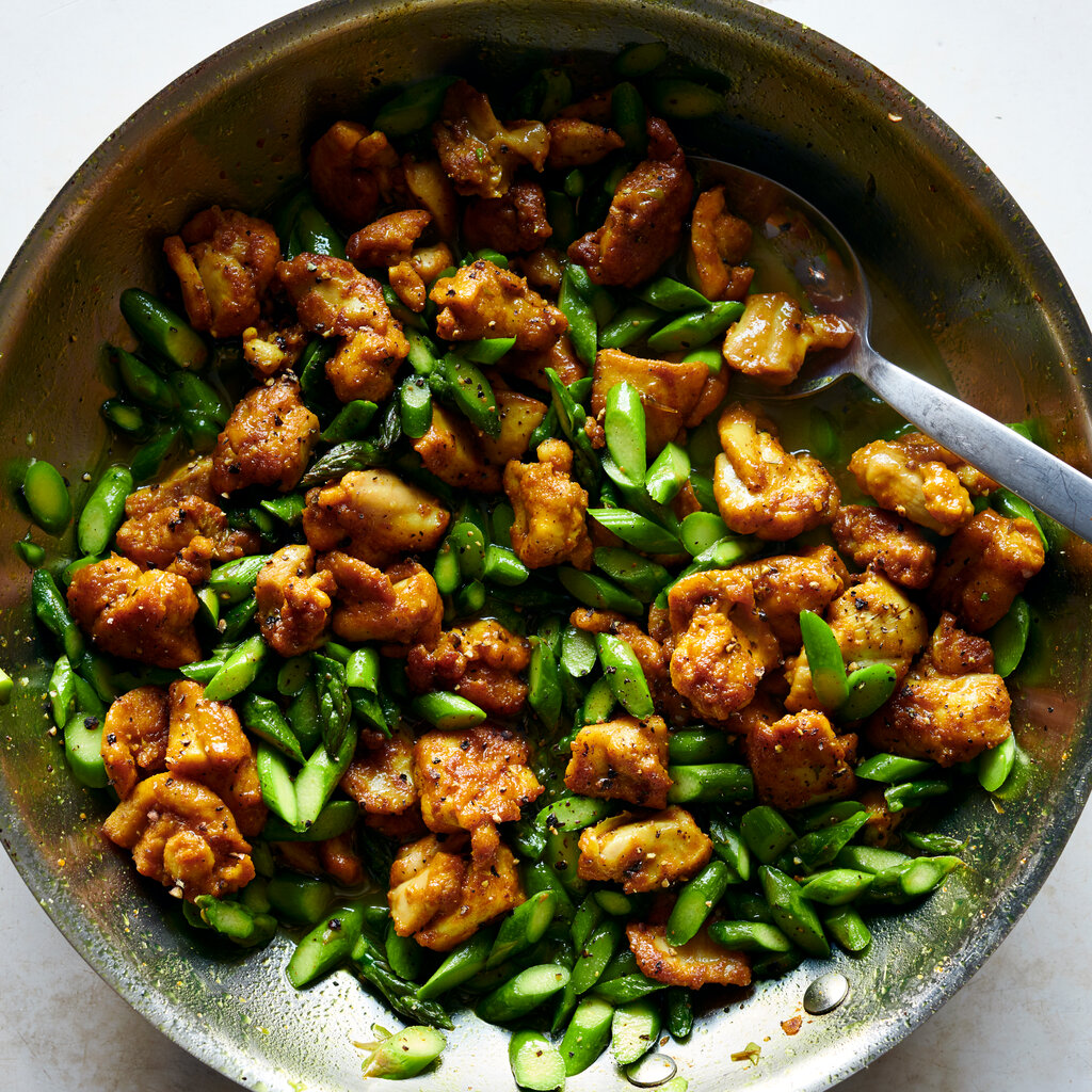 Top down image of a bowl of Turmeric Black Pepper Chicken and Asparagus.