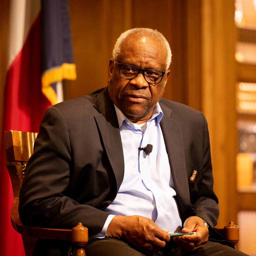 Justice Clarence Thomas in a suit without a tie. 